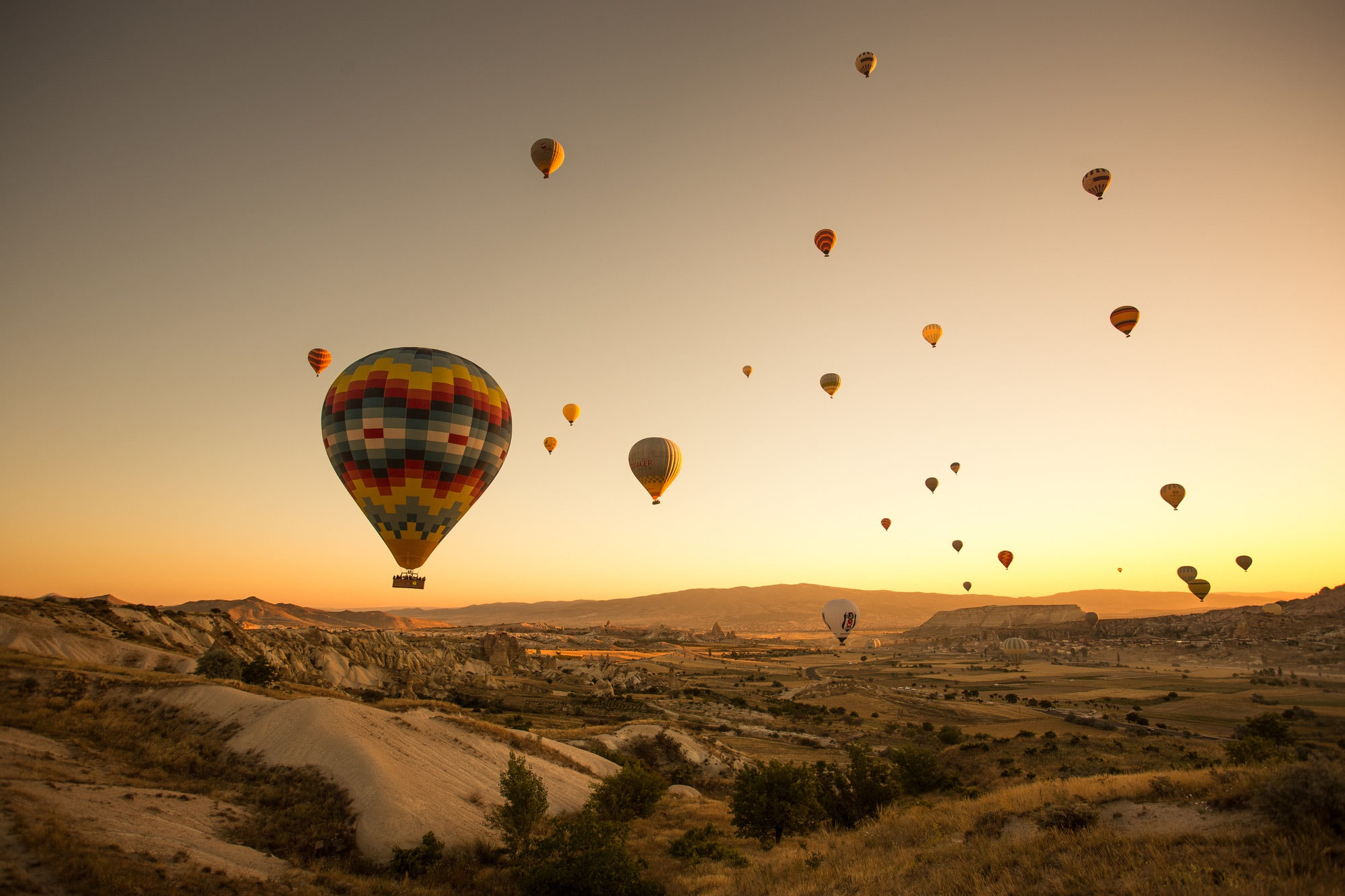 Hot air balloons floating over Cappadocia at sunrise